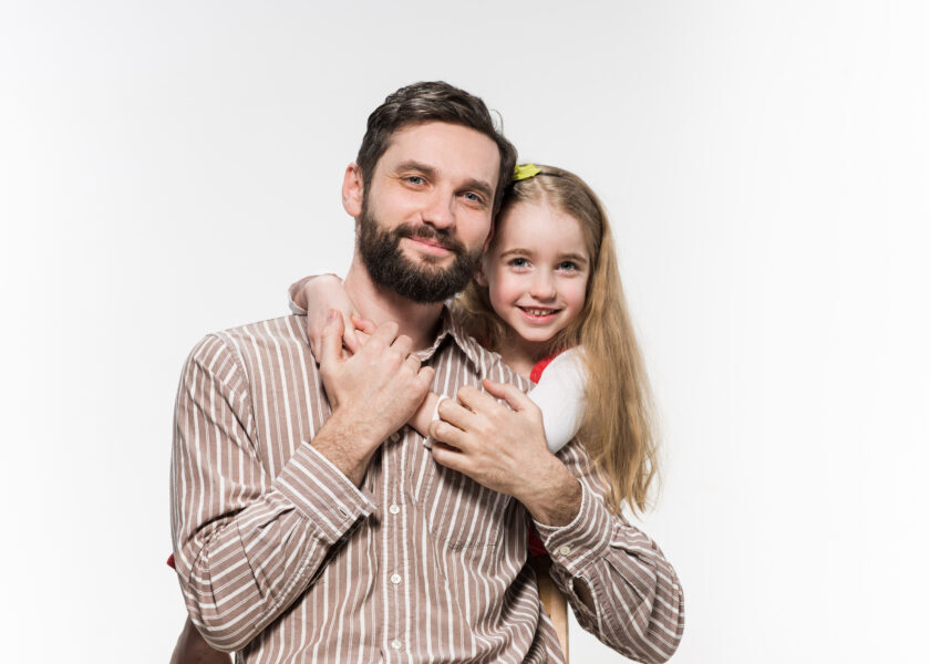 Girl hugging her father  over a white background